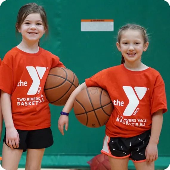 two young girls playing basketball