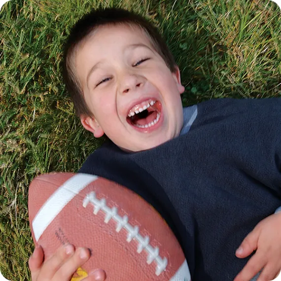 young boy playing football