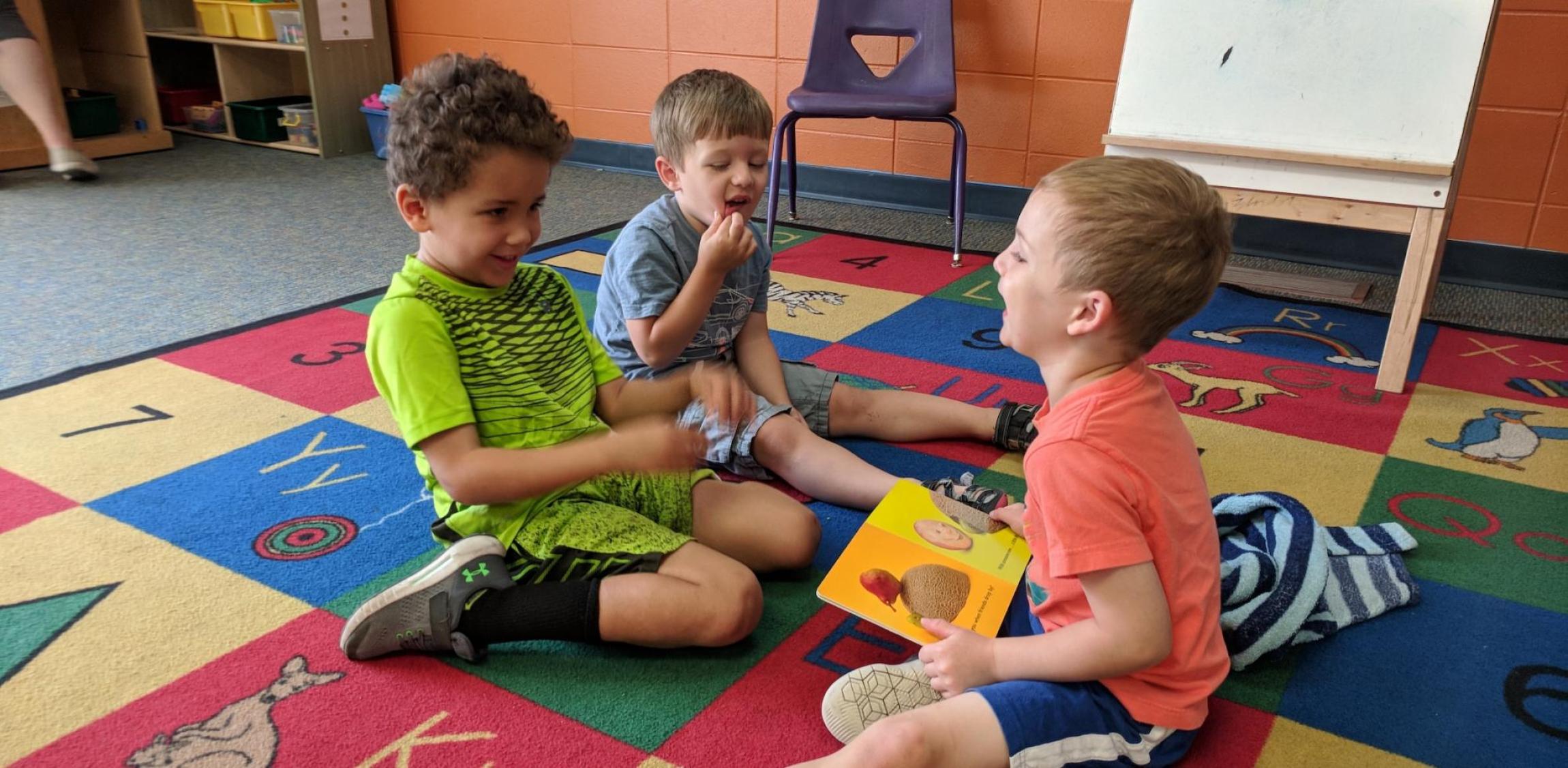 three young boys playing at preschool